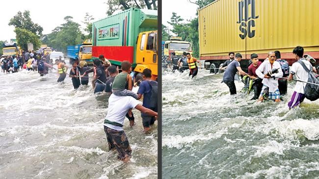 people wade through flood waters in feni on thursday