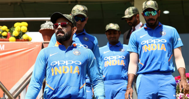 indian players walk with army camouflage caps