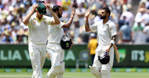 kohli and pujara high five after seeing out a session