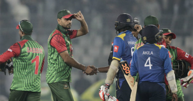 mashrafe holding cap while shaking hand with sri lankab batsman