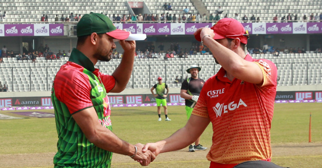 mashrafe holding cap while shaking hand