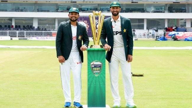 shanto and shan pose with the series trophy