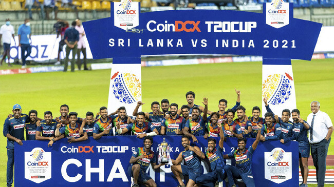 sri lanka players and support staff pose with the winners trophy