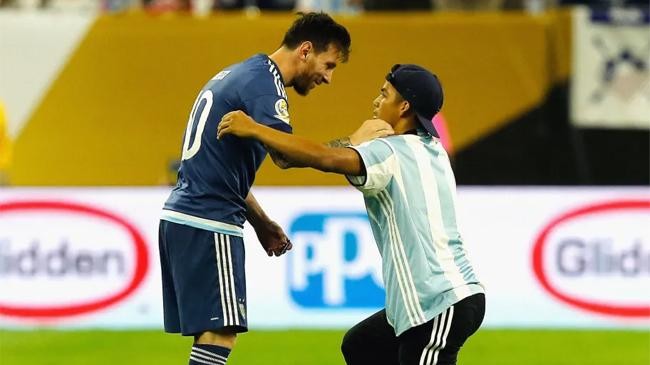 messi with fan in field