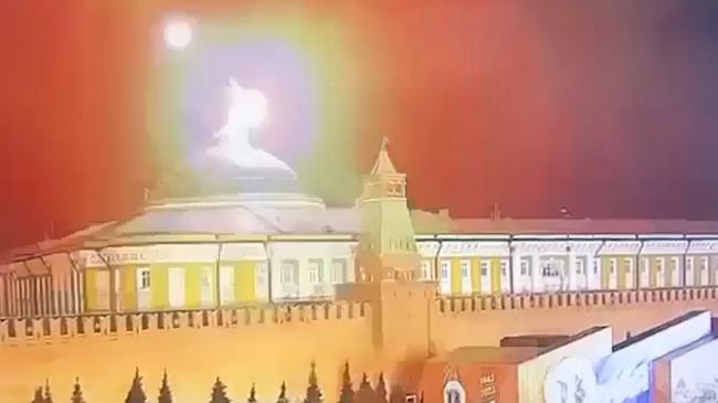 a flying object exploding in an intense burst of light near the dome of the kremlin senate building