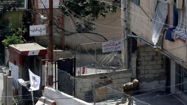 a lebanese soldier runs for cover at the entrance to the ain al helweh camp