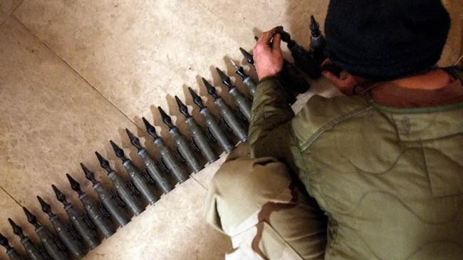 a us soldier with 25mm rounds of depleted uranium ammunition