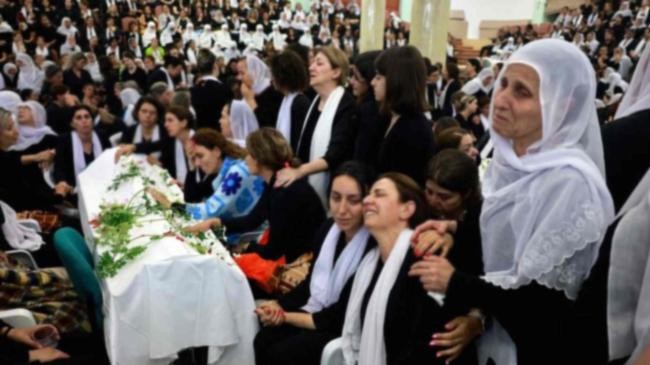 druze women mourn by a coffin during a funeral of a person