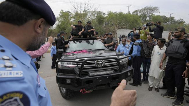 imran khan arrives to appear in a court by a heavily secured vehicle