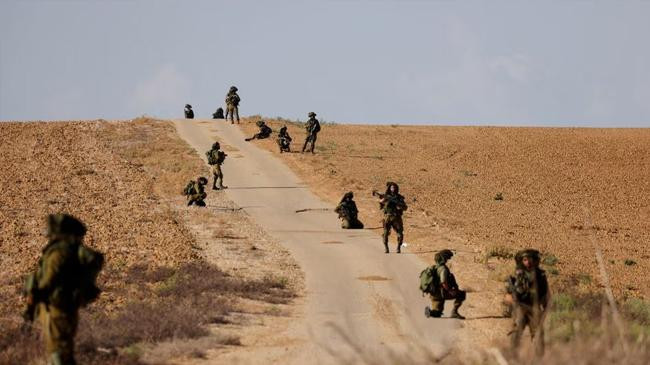 israeli soldiers patrol an area near israels border with the gaza strip