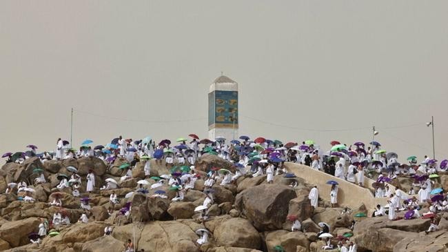 muslim pilgrims gather around mount arafat