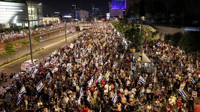 people attend a demonstration against israeli prime minister