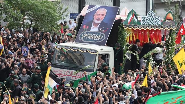 people gather around a truck carrying the coffins of ismail haniyeh