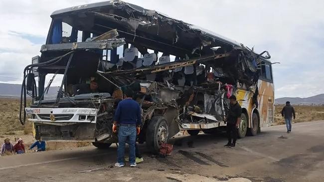 people inspect the wreckage of a bus involved in the collision