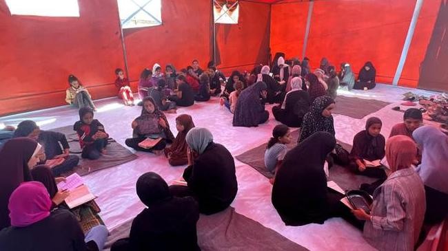 women in tent mosque